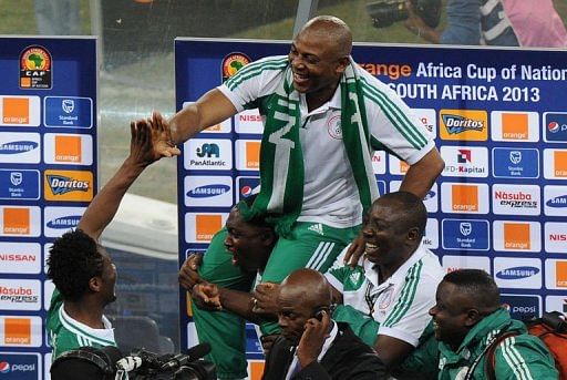 Nigeria's head coach Stephen Keshi (C) is carried by staff members on February 10, 2013 at Soccer City stadium
